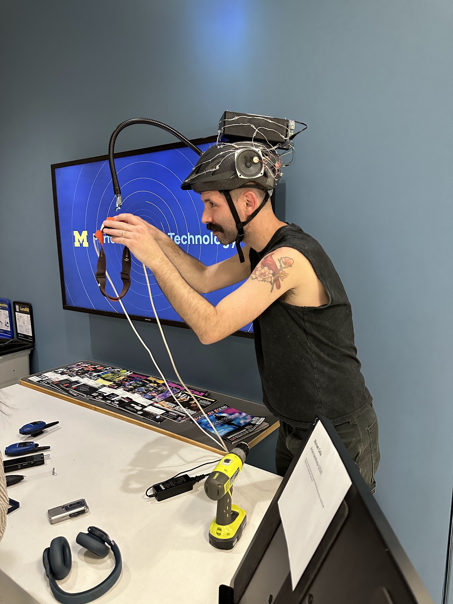 Michael wearing the helmet and interacting with a headlamp, pointing it at the inductors at the tip of the antenna