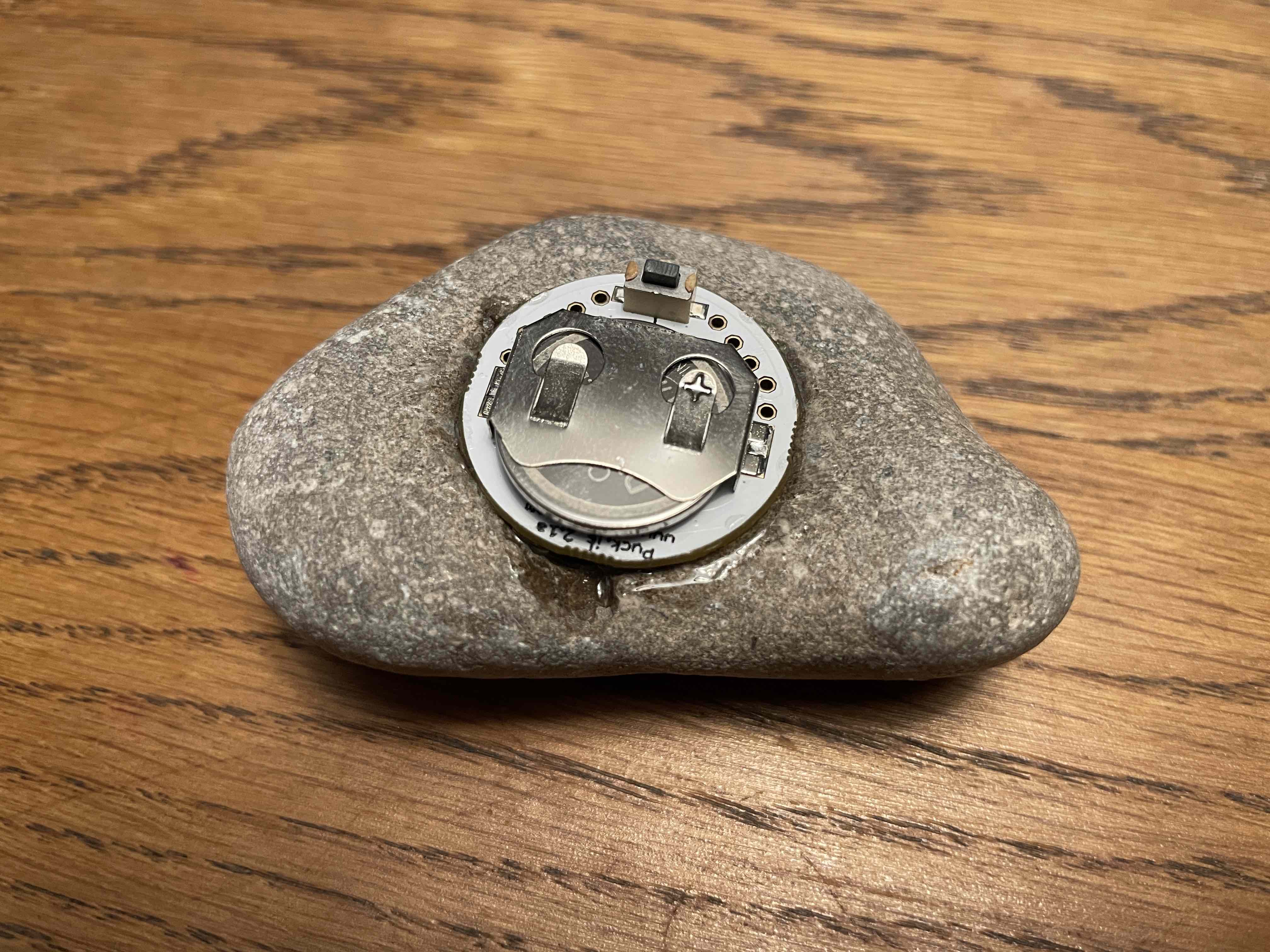 a Petoskey stone containing an embedded PuckJS microcontroller